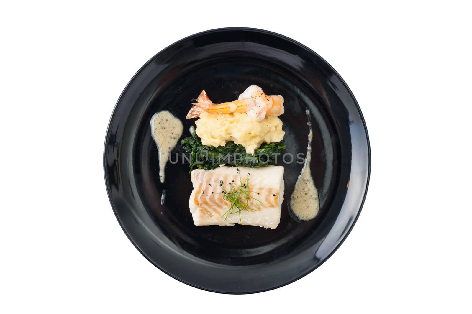 Cod fish steak with shrimp, mesh potato, and vegetable, modern style food isolated on white background with clipping path