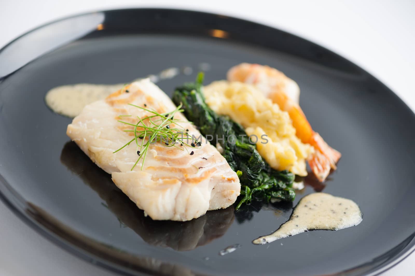 Cod fish steak with shrimp, mesh potato, and vegetable, modern style food