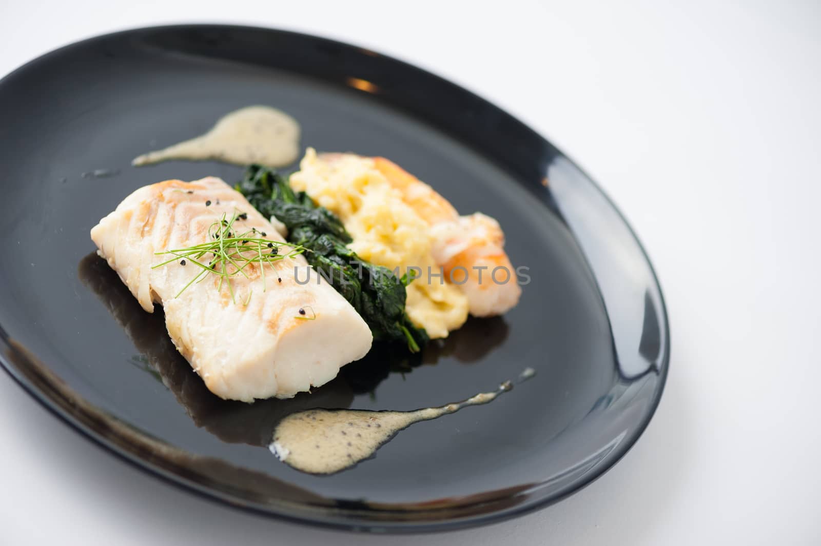 Cod fish steak with shrimp, mesh potato, and vegetable, modern style food