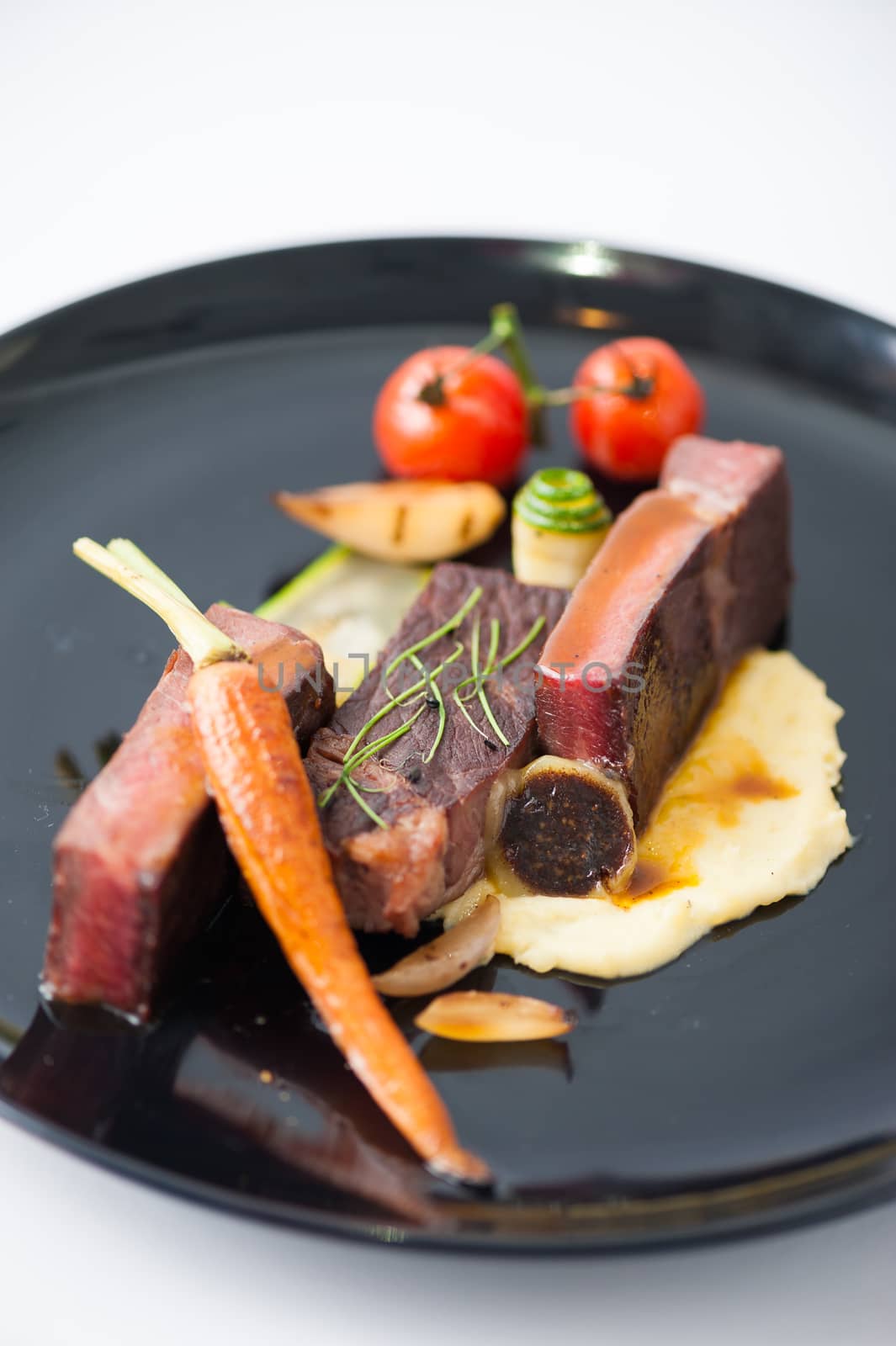 Dry-aged beef steak with mesh potato and vegetable, a modern style food