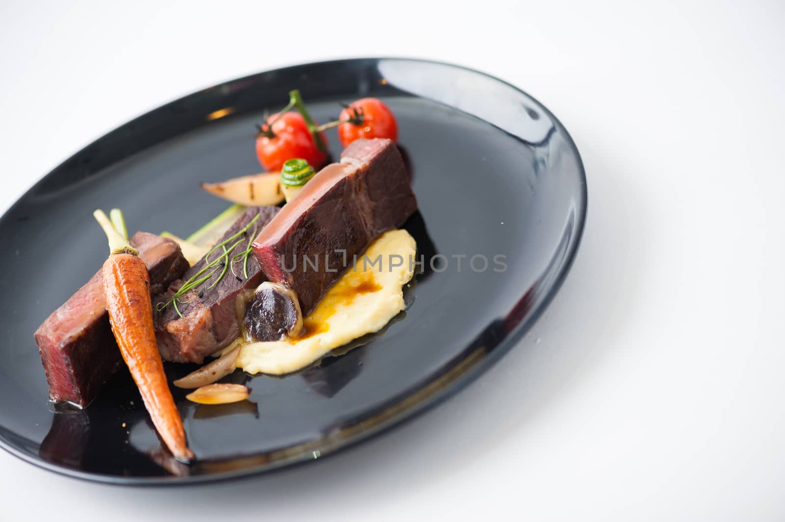 Dry-aged beef steak with mesh potato and vegetable, a modern style food