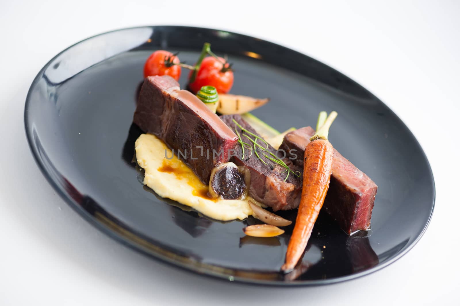 Dry-aged beef steak with mesh potato and vegetable, a modern style food