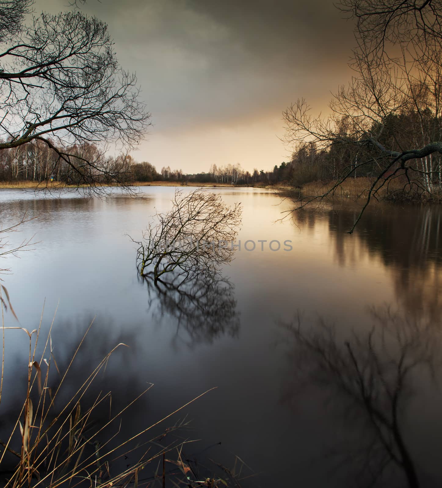 misty autumn sunset  in lake by dolnikow