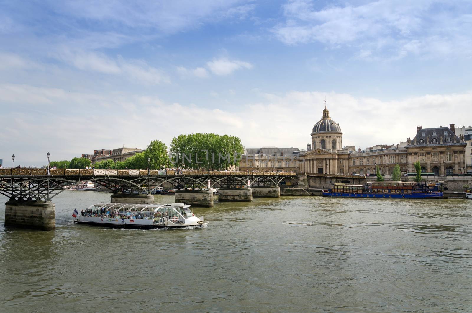 Institut de France and the Pont des Arts bridge across river Seine in Paris by siraanamwong