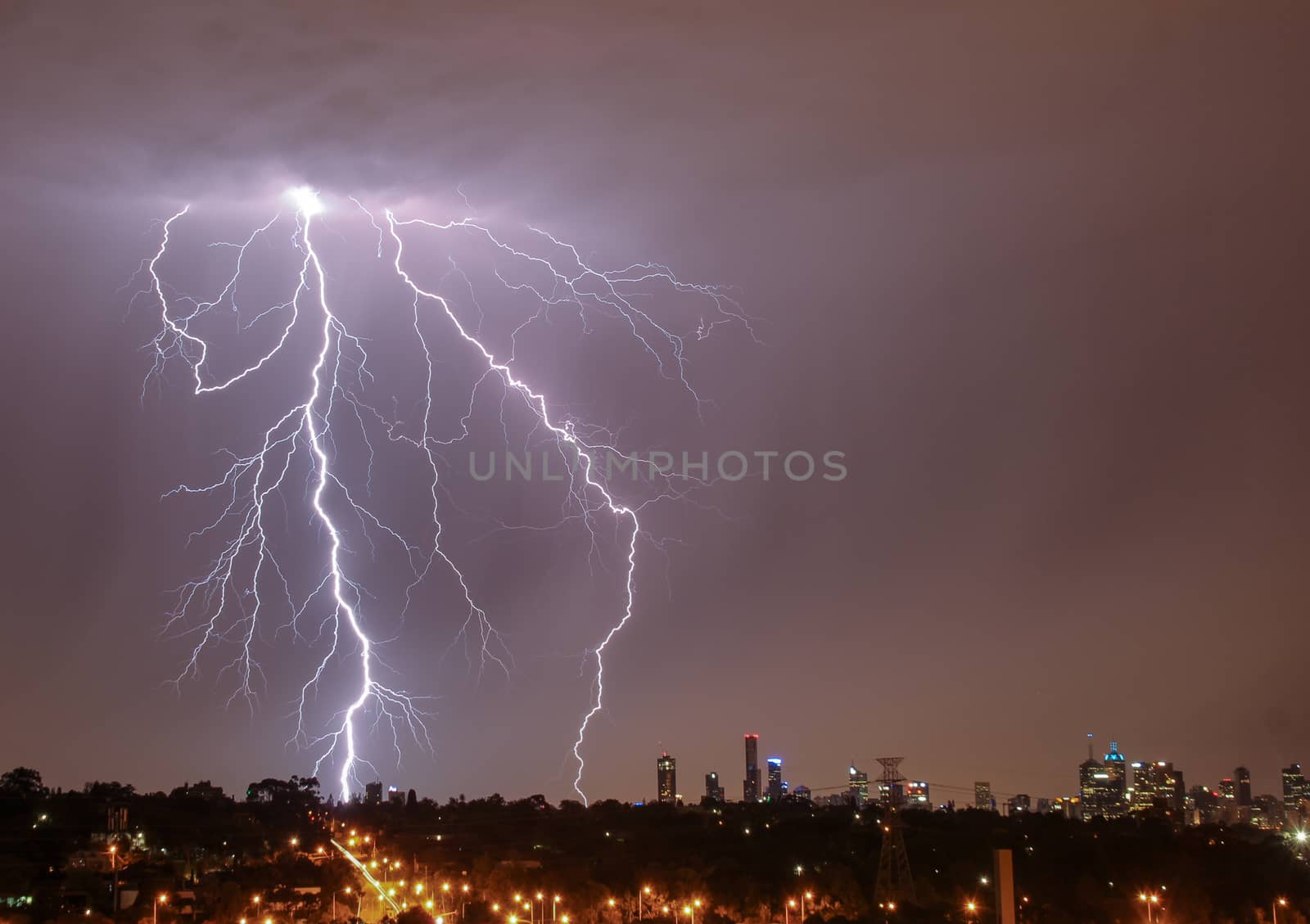 Lightning over city skyline by danieldep