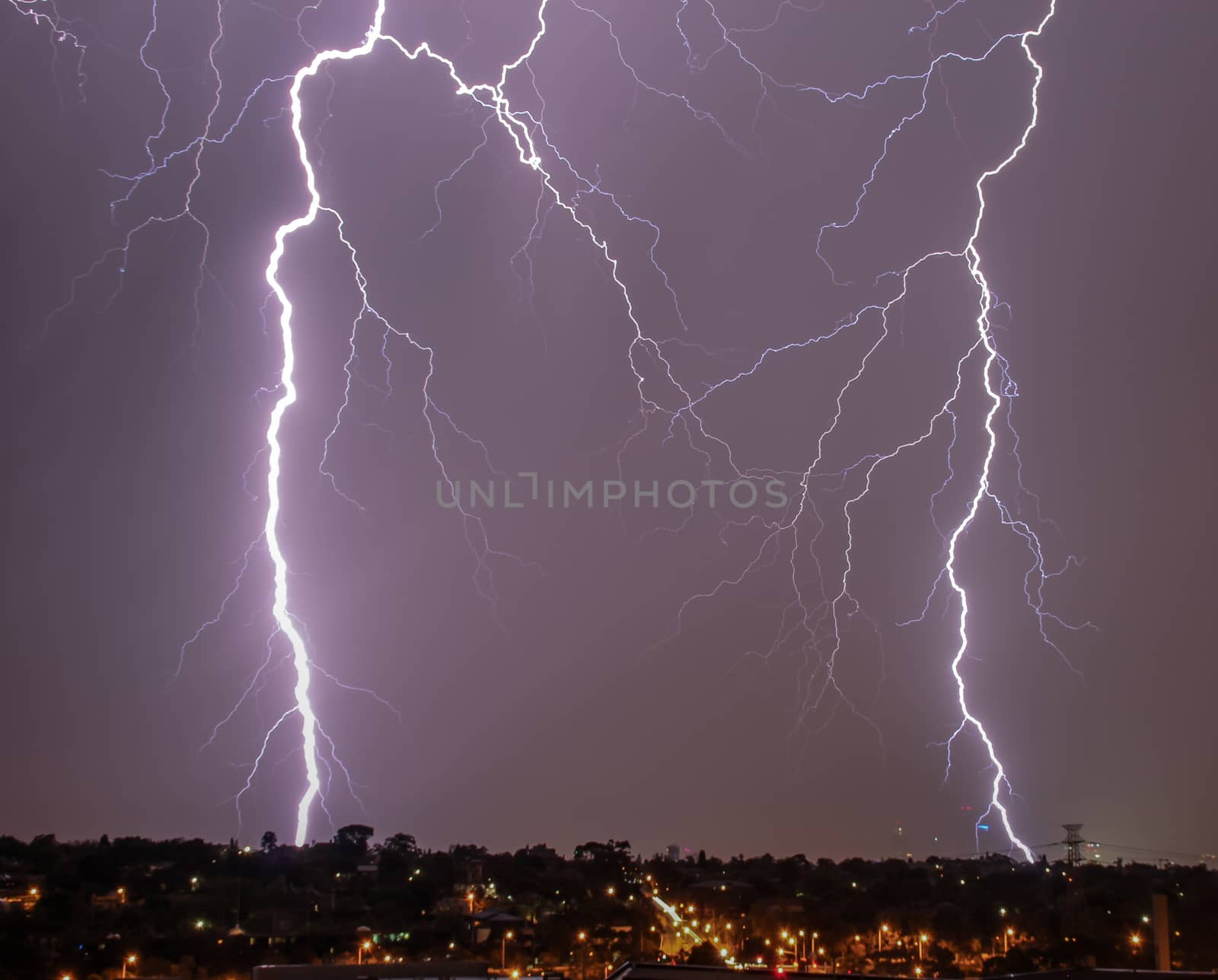 Lightning over city skyline by danieldep