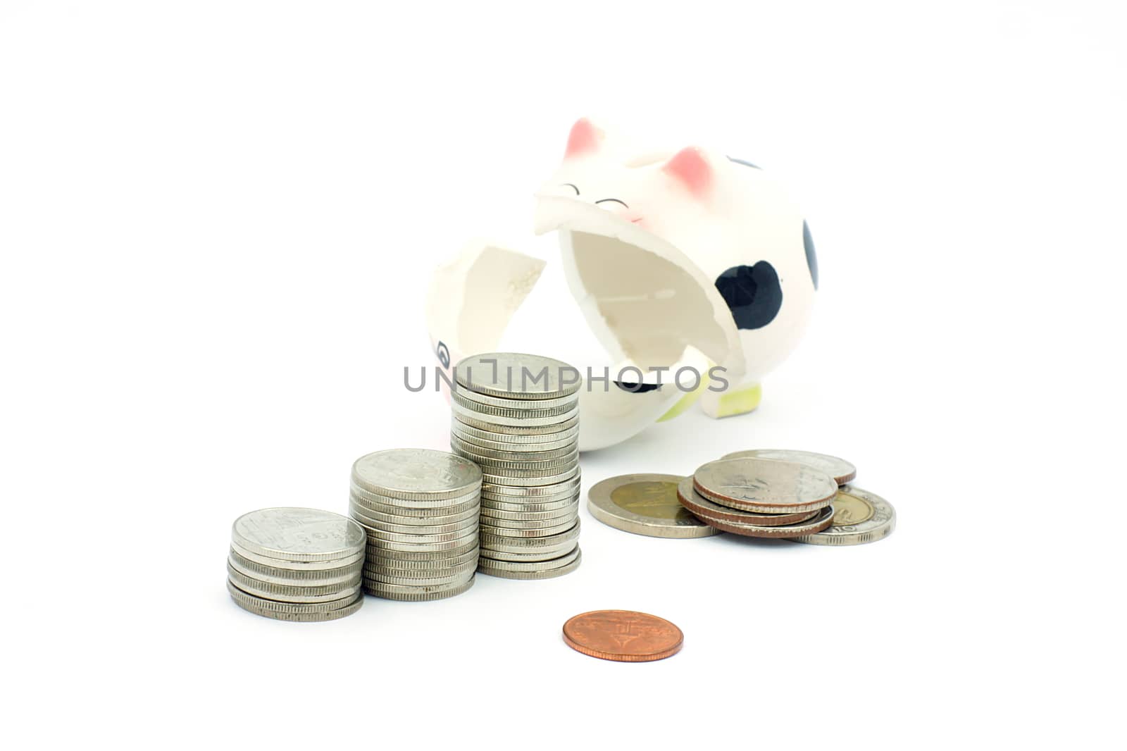 Thai stack coins with broken piggy bank on white background, financial concept photo