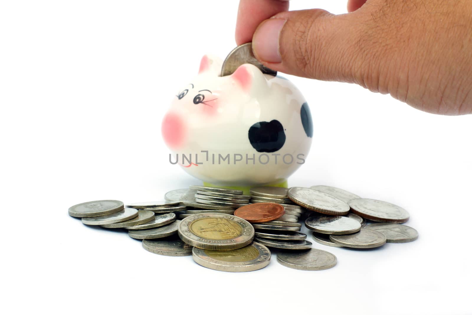 Thai stack coins with broken piggy bank on white background, hand put the coin into piggy bank, financial concept photo