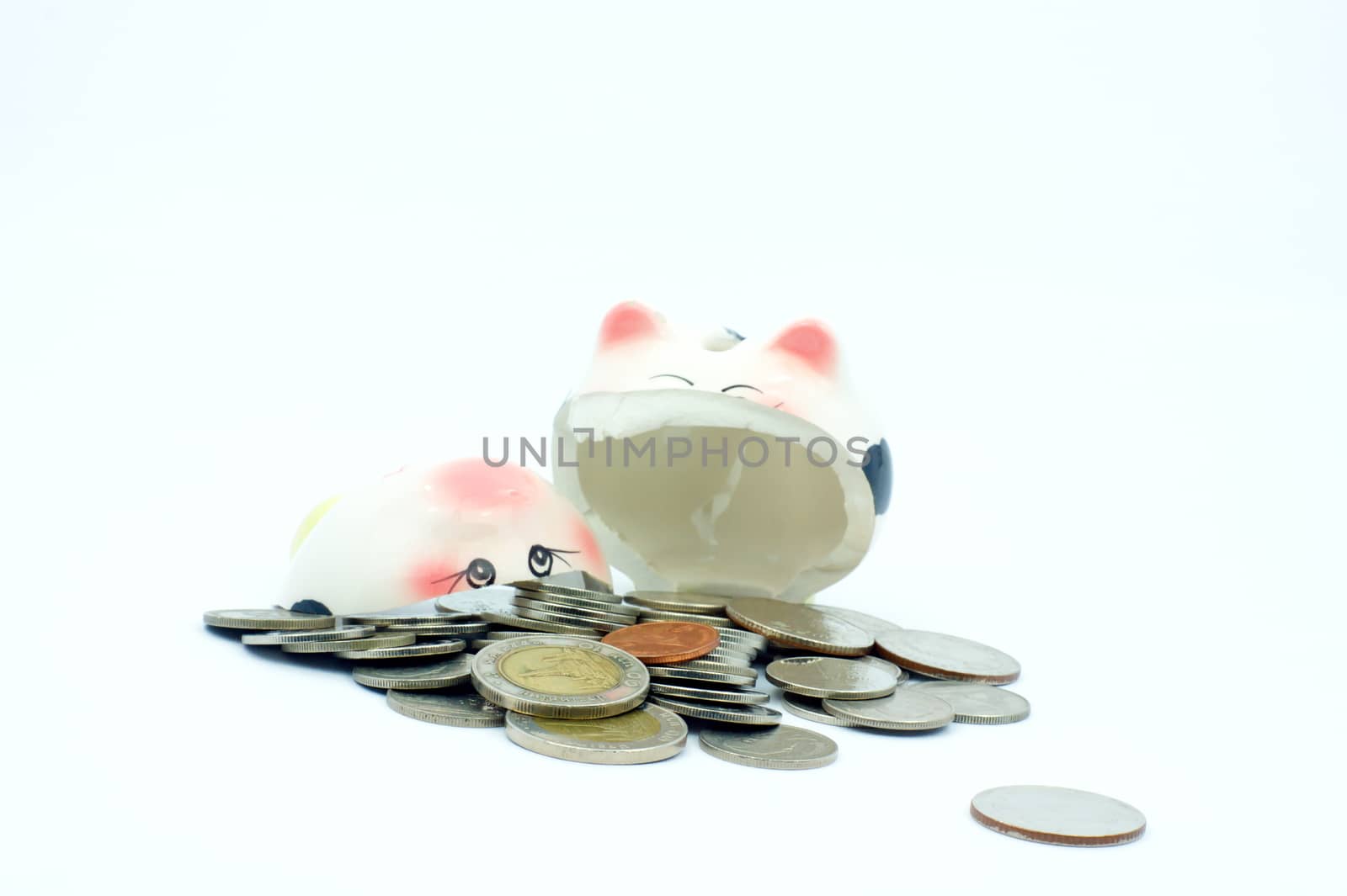 Thai stack coins with broken piggy bank on white background, financial concept photo