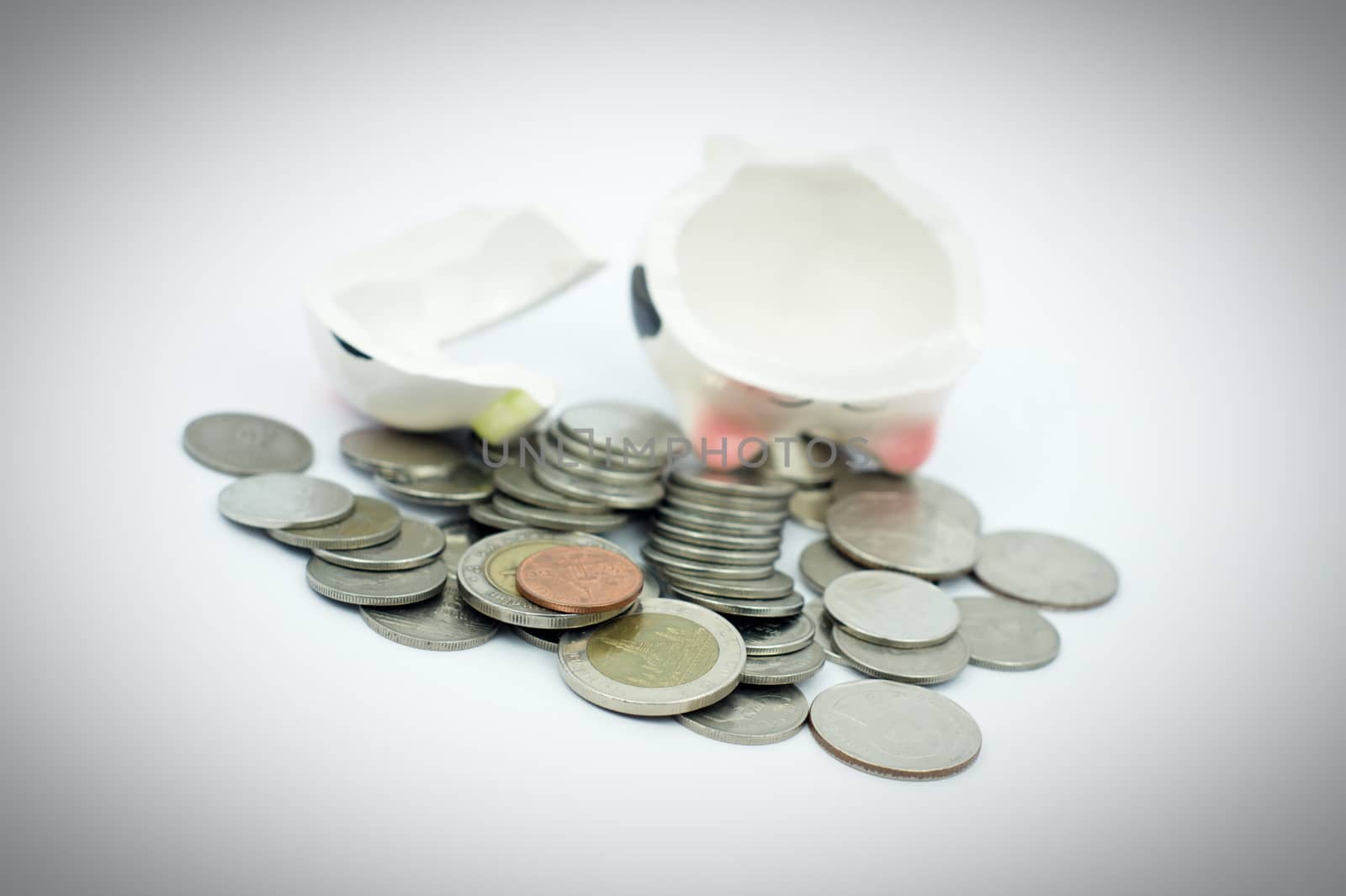 Thai stack coins with broken piggy bank, Fill vignette effect