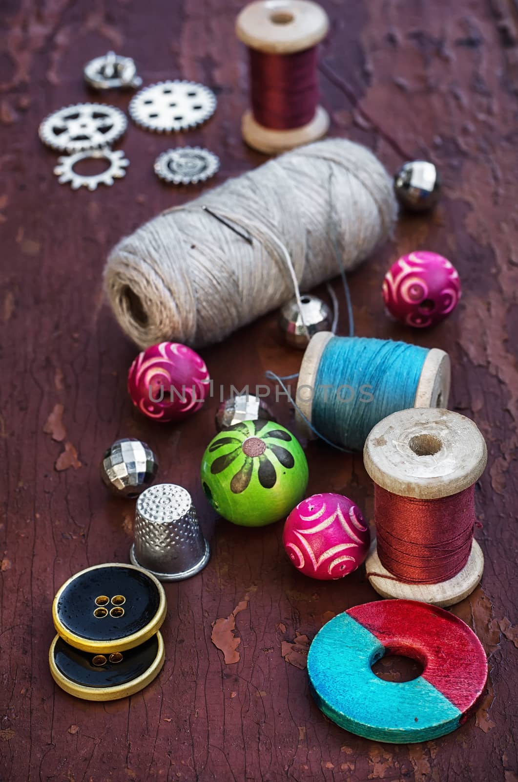 set of threads and buttons on old wooden background