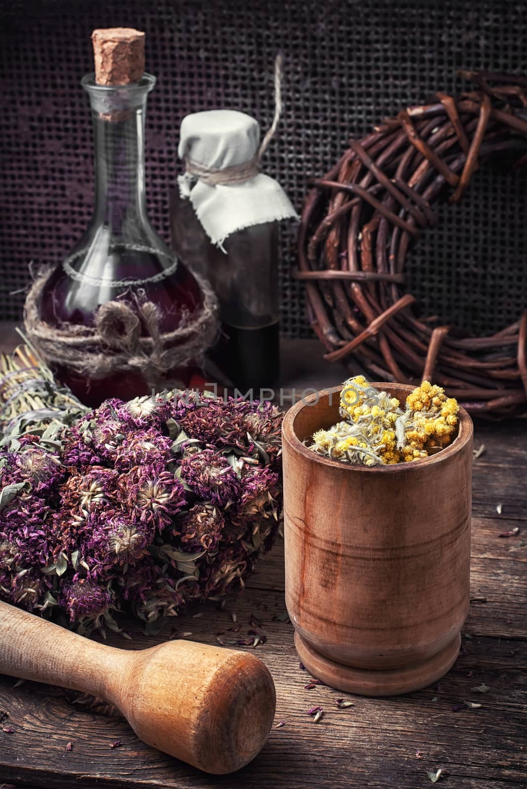 Cut  bunch medicinal plants,mortar on wooden table.Toned.