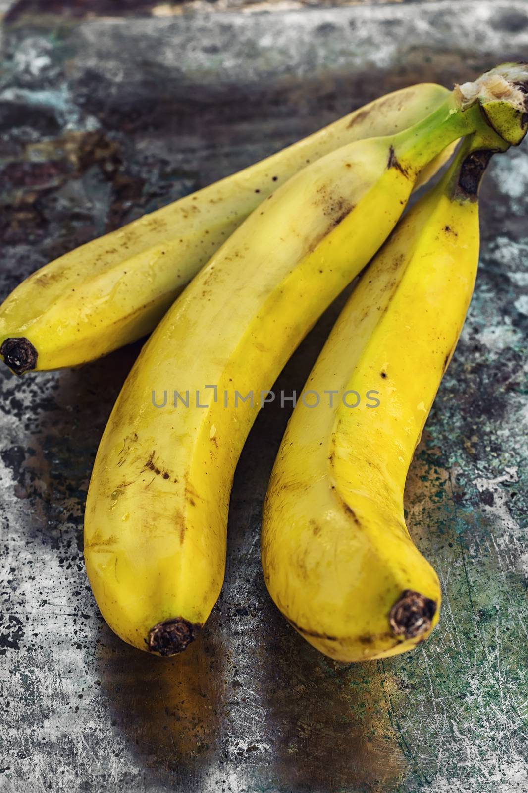 Ligament large ripe and fragrant bananas on wooden background.