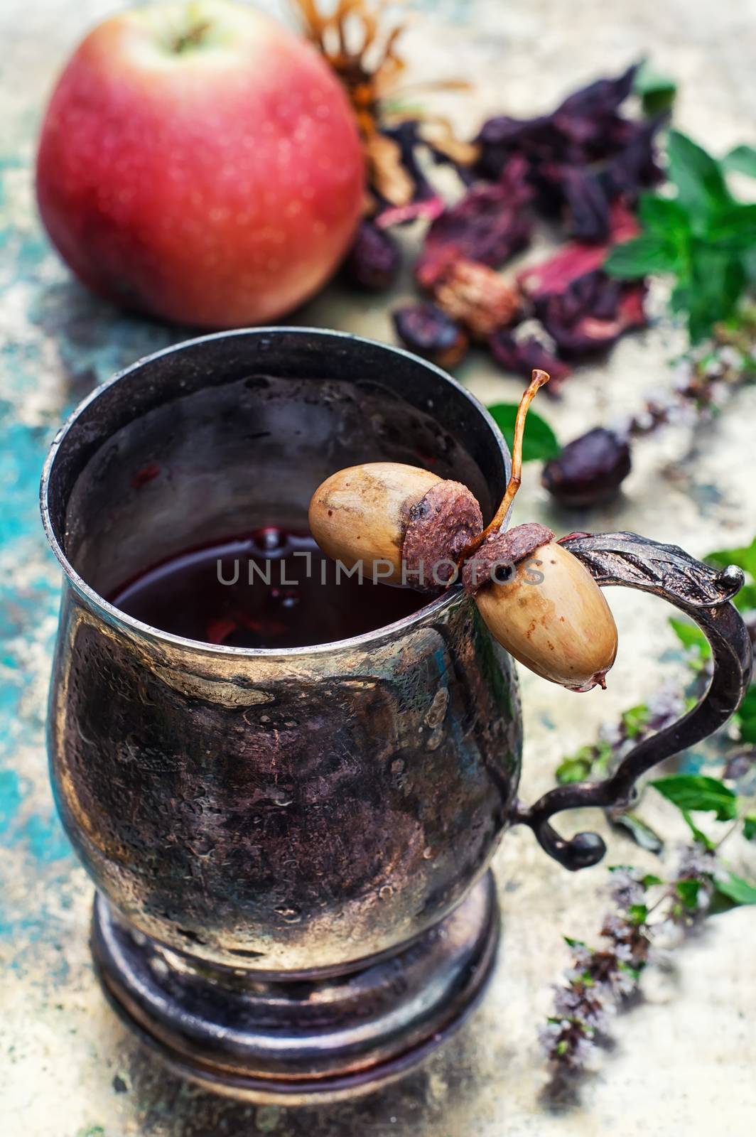 Herbal tea in iron stylish mug for medicinal herbs with fruit