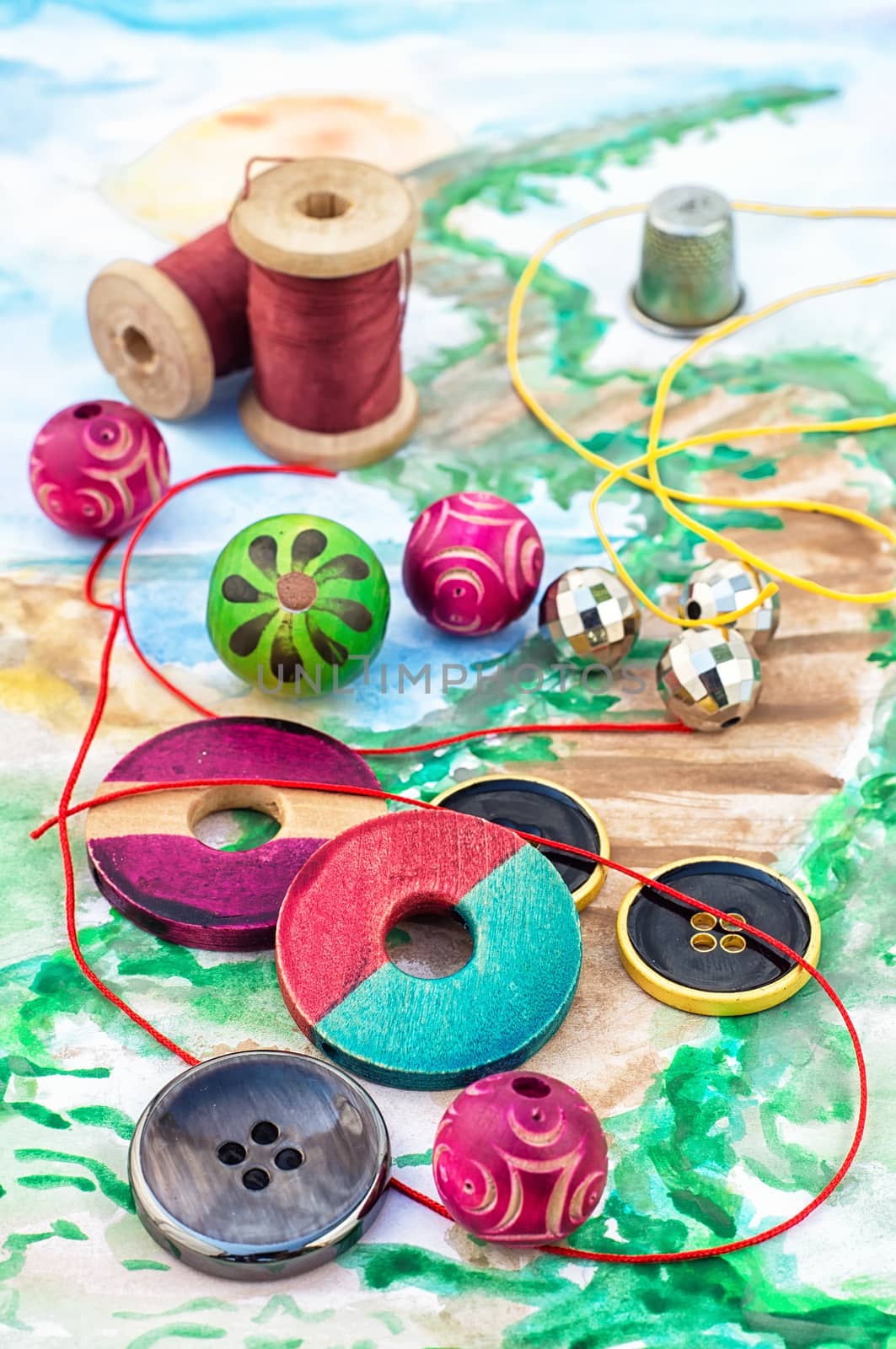 accessories of beads and threads for needlework on wooden plank