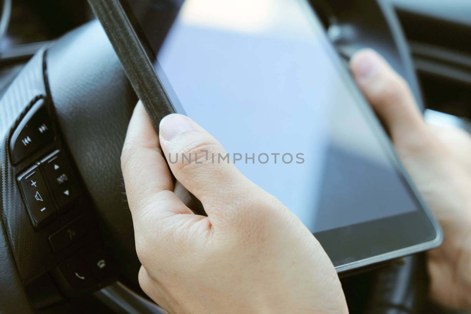 image of using a digital tablet inside of a car.
