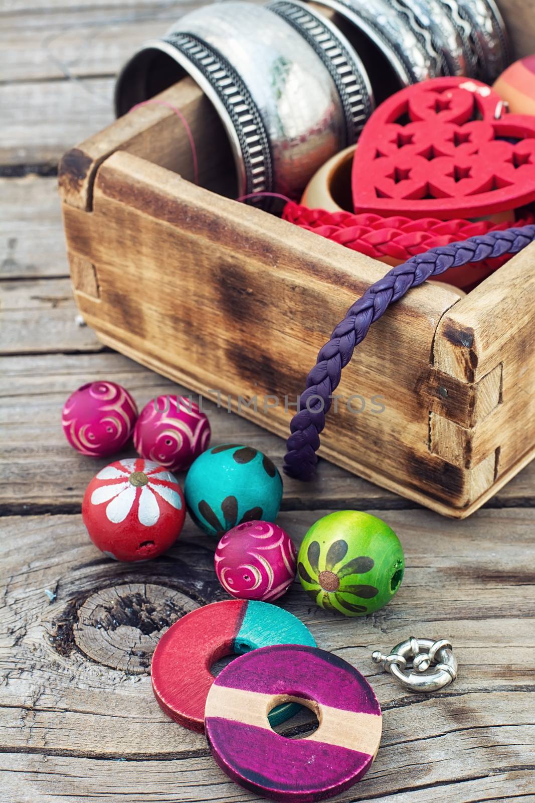 accessories of beads and threads for needlework on wooden plank