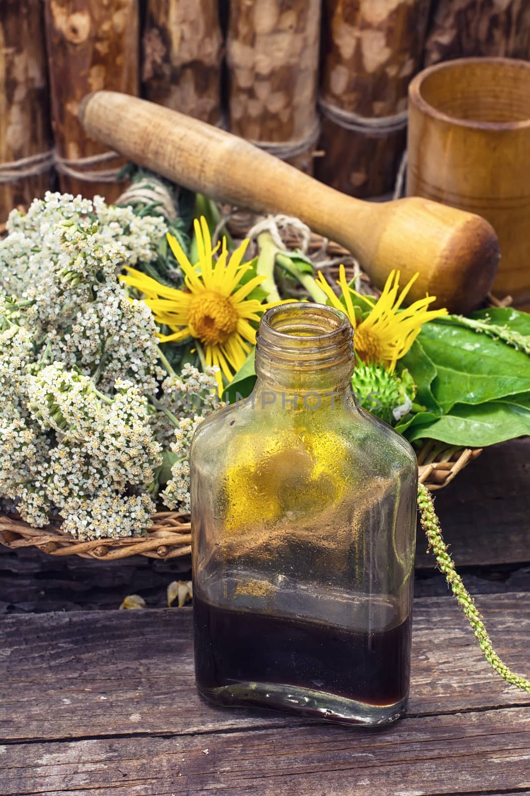 Cut  bunch medicinal plants,mortar on wooden table.Toned.