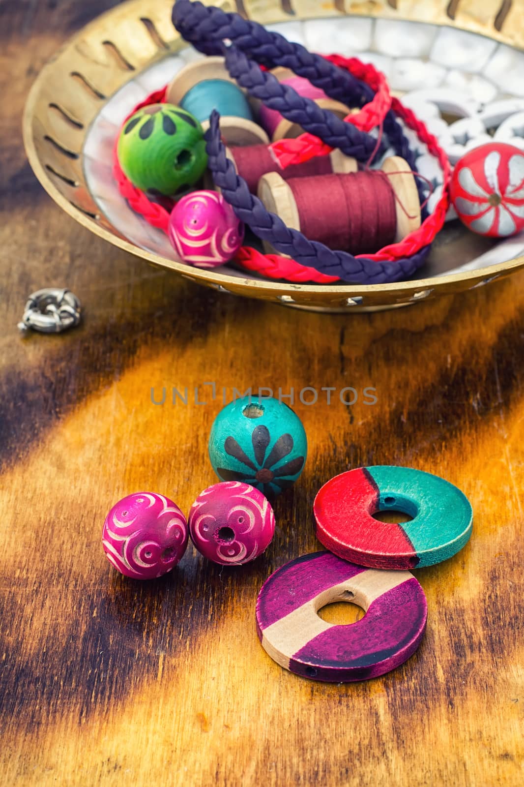 beads and jewelry for handmade on light orange plate