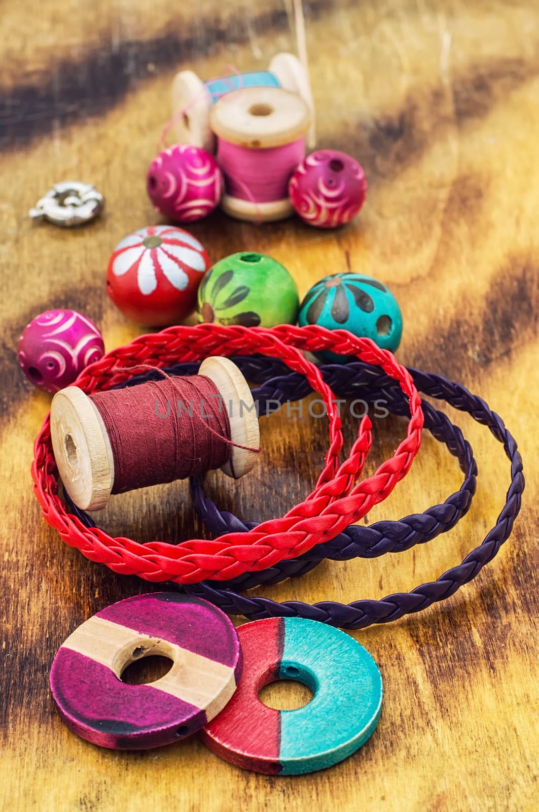 beads and jewelry for handmade on light orange plate