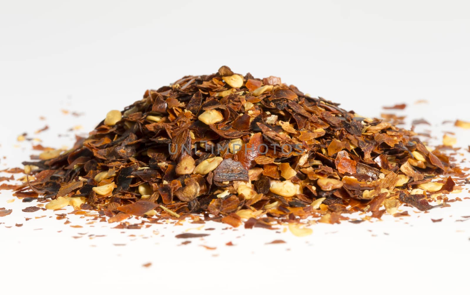Dried Chili Pepper in a Pile close up with white background.