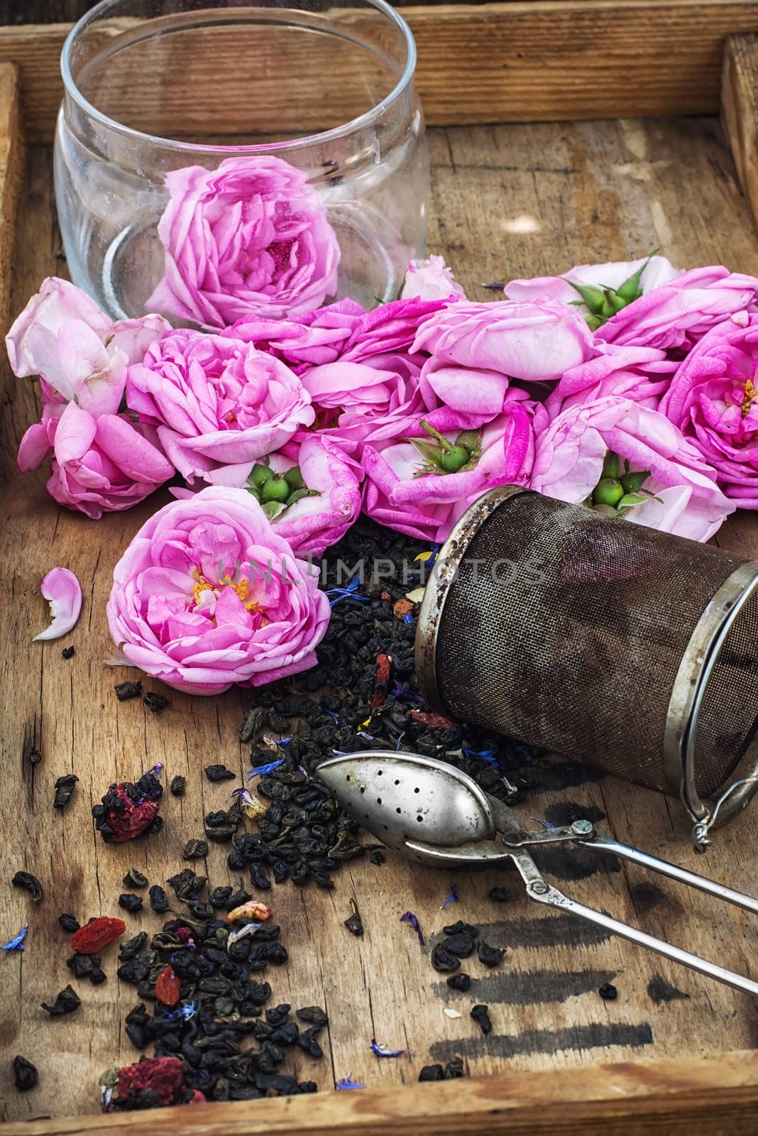 buds of the tea roses in wooden box with welding in rustic style