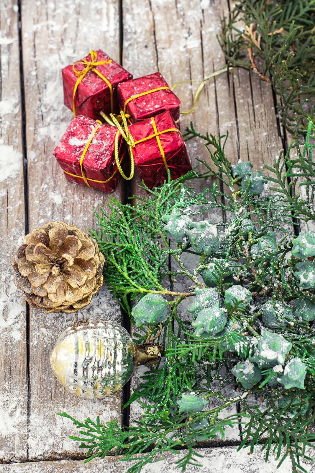 Christmas decorations with red boxes on wooden background decorated with fir branch
