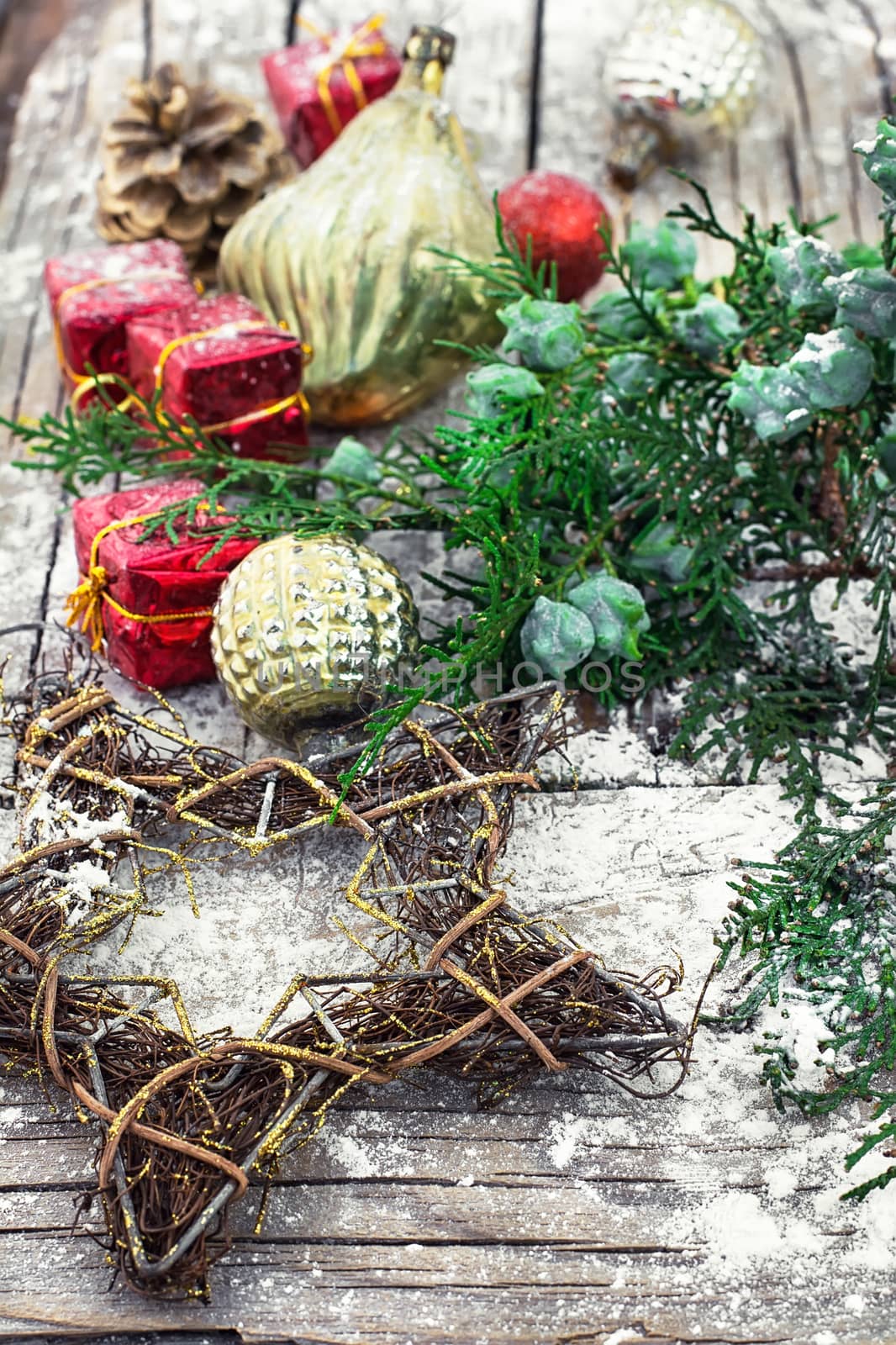 Christmas decorations with red boxes on wooden background decorated with fir branch