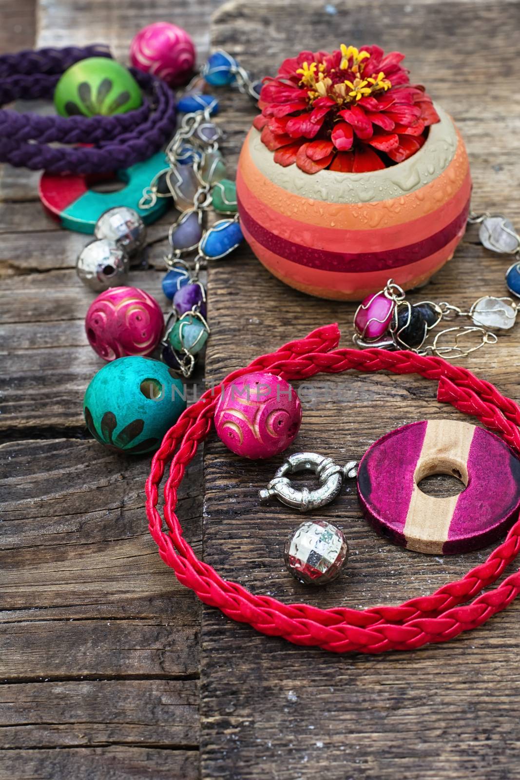 accessories of beads and threads for needlework on wooden plank