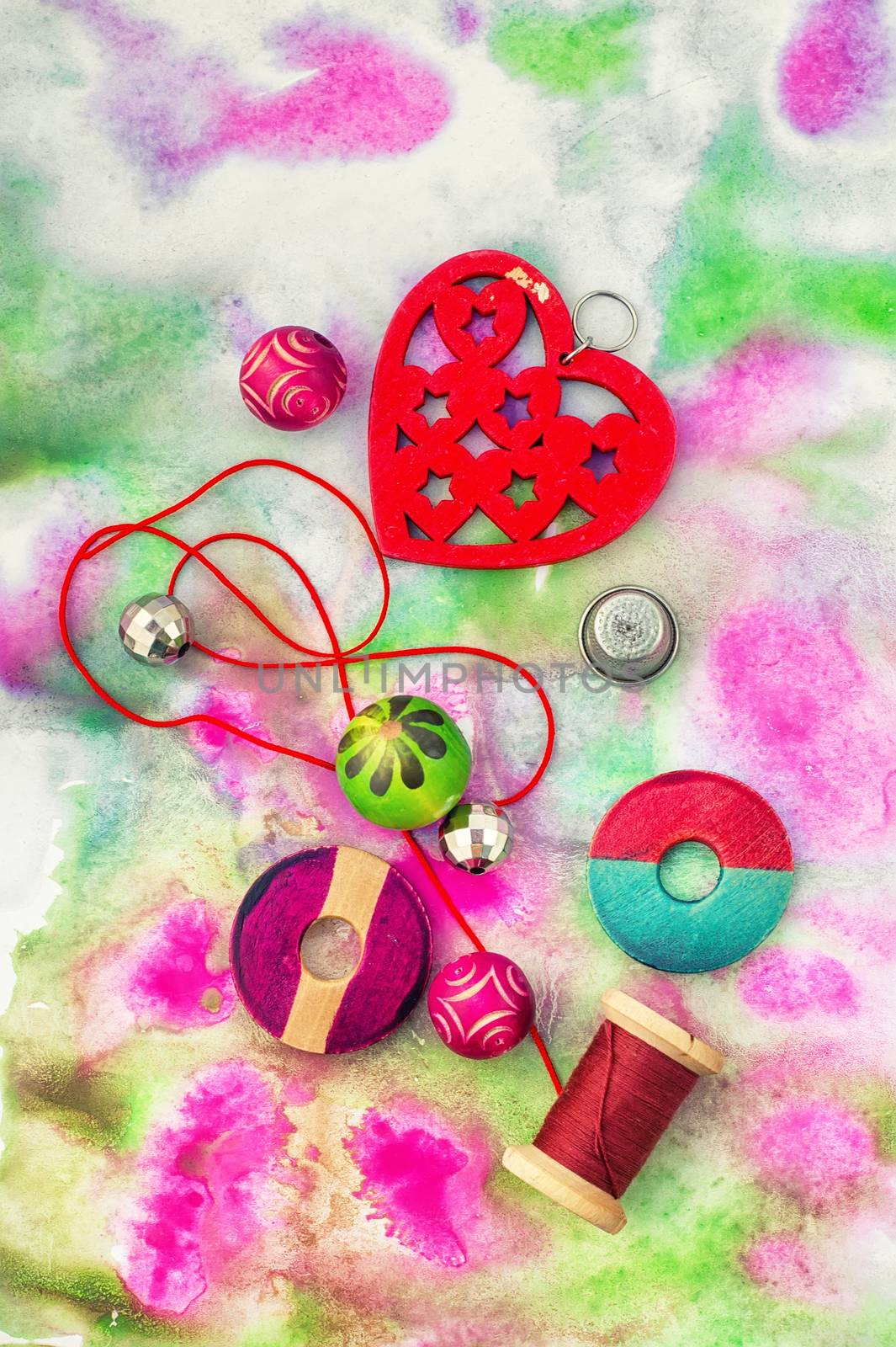 Set beads,threads and fittings on  painted background.