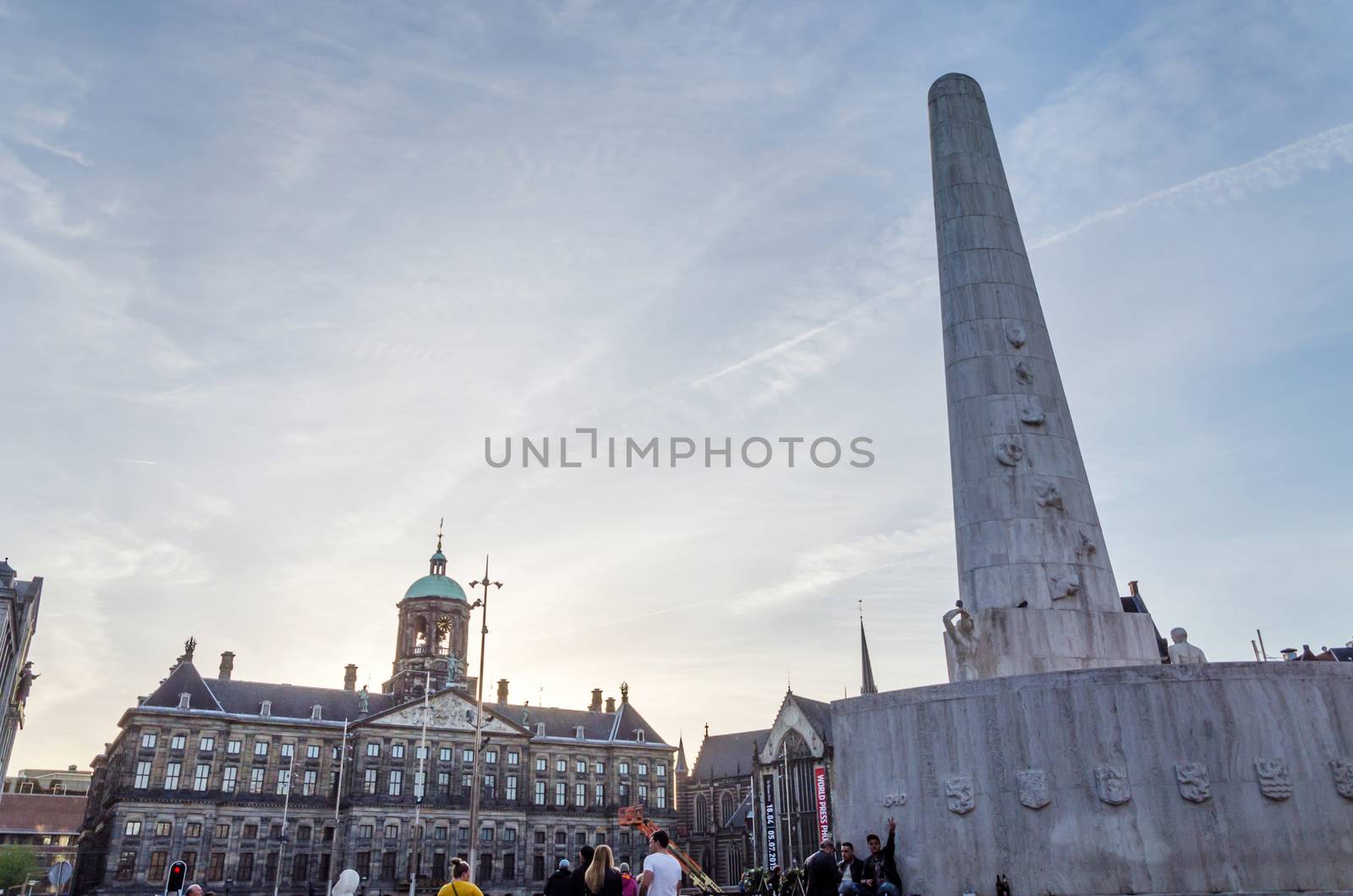 Amsterdam, Netherlands - May 8, 2015: People visit The Dam monument in Amsterdam by siraanamwong