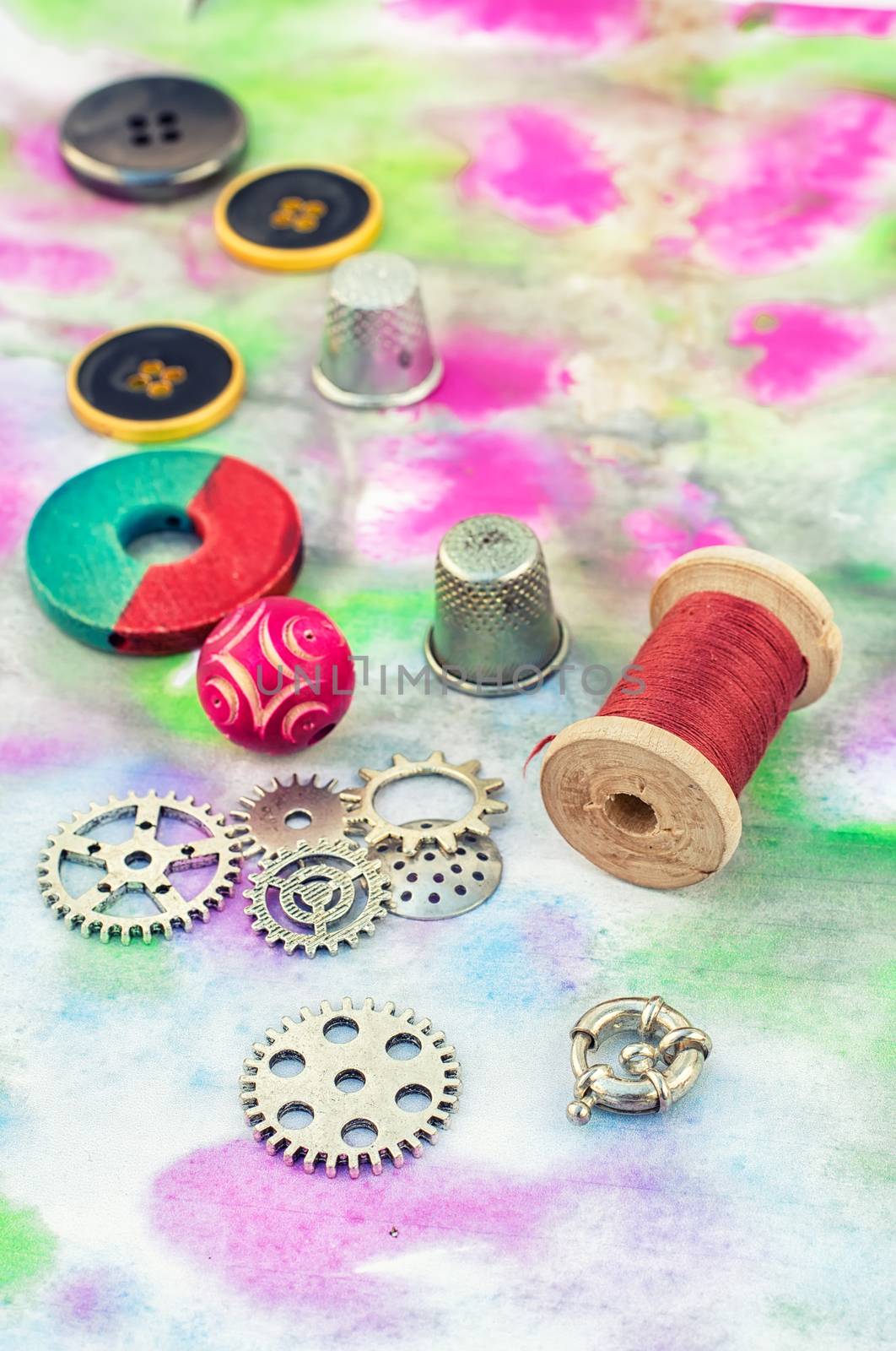 Set beads,threads and fittings on  painted background.
