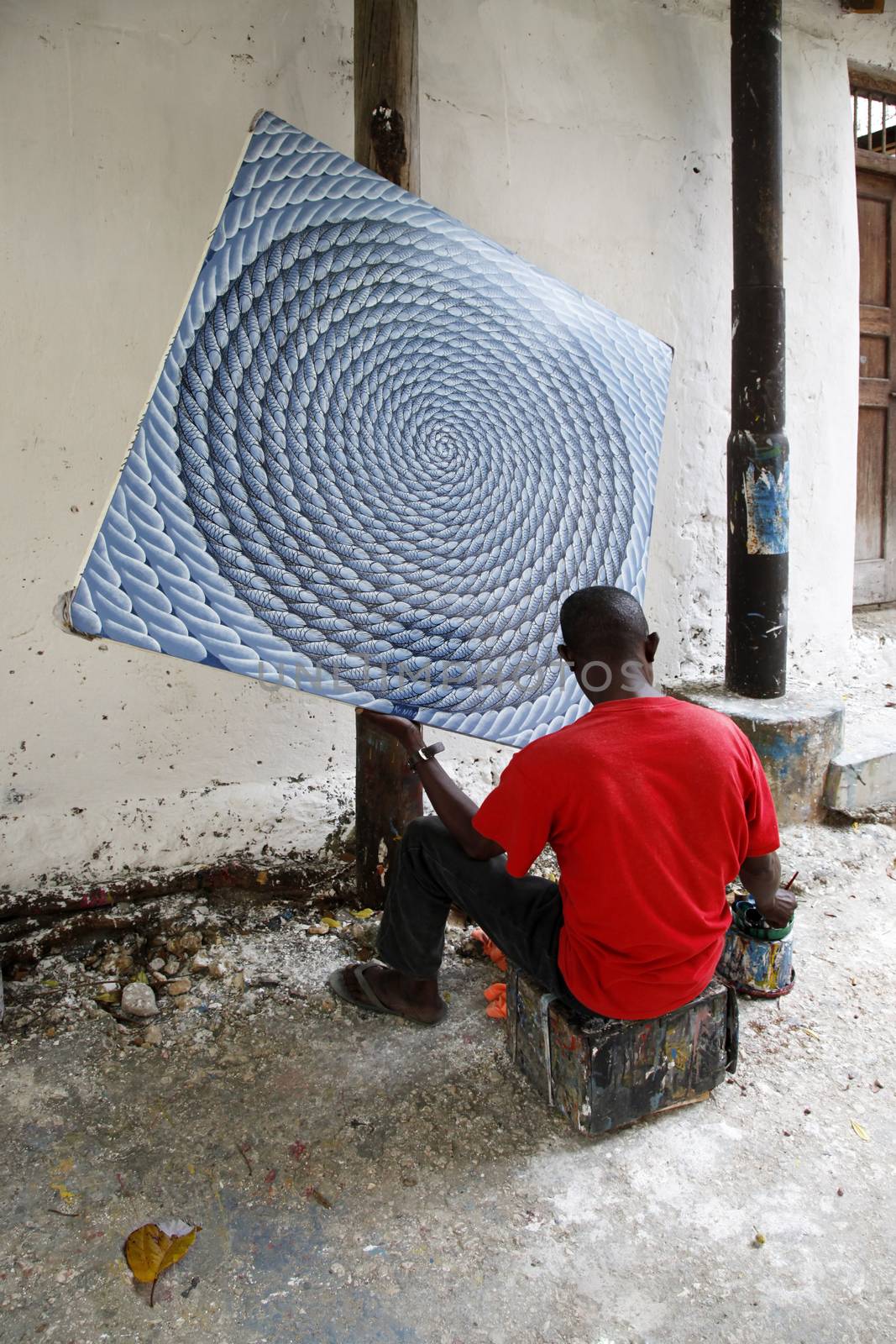 Stone Town, Zanzibar, Tanzania - December 30, 2015:  The artist paints a picture of the street Stone Town, Zanzibar