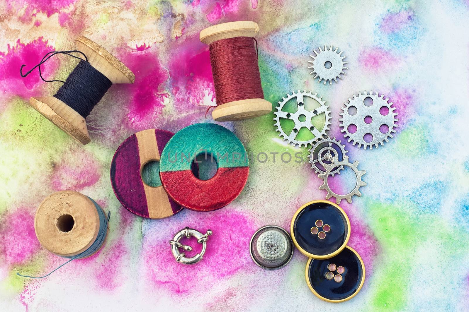 accessories of beads and threads for needlework on wooden plank