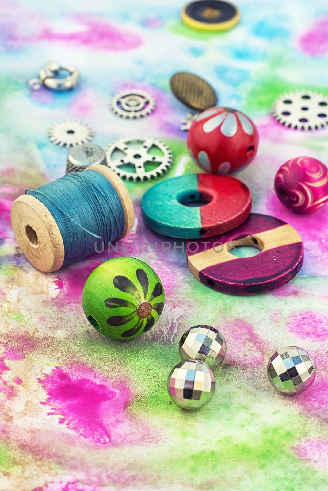 accessories of beads and threads for needlework on wooden plank