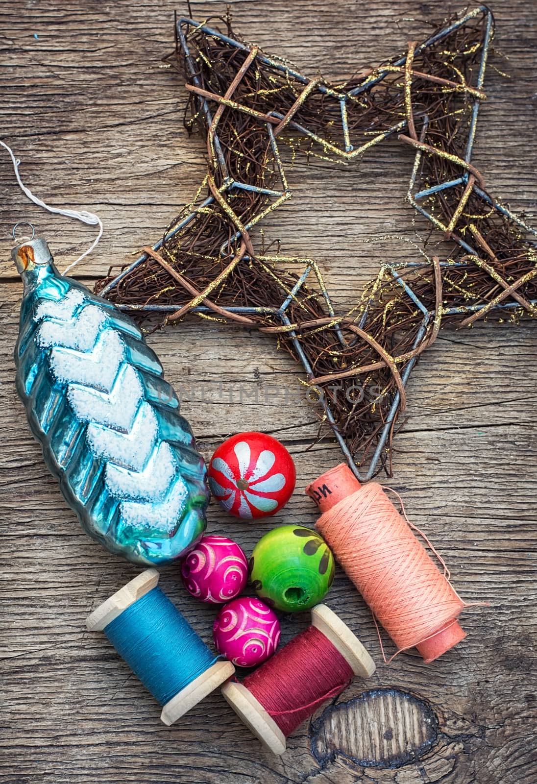 spool of thread and Christmas decorations on wooden background