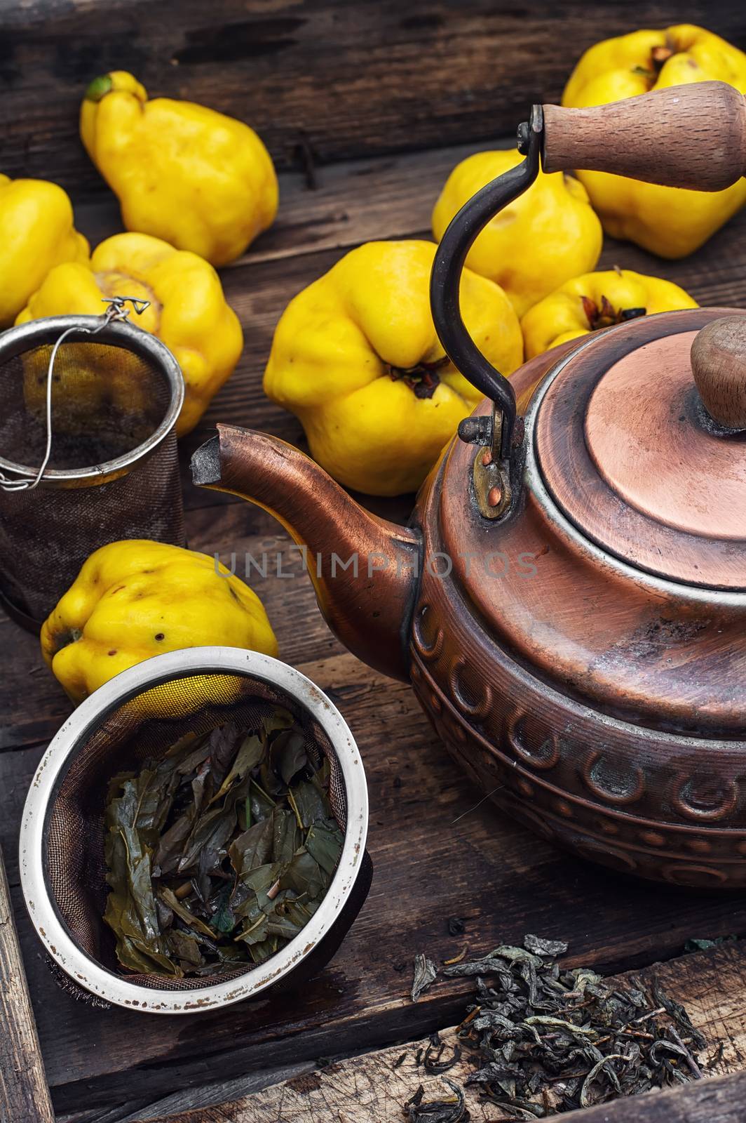 Copper kettle brewing and quinces in an old stylish derevna box