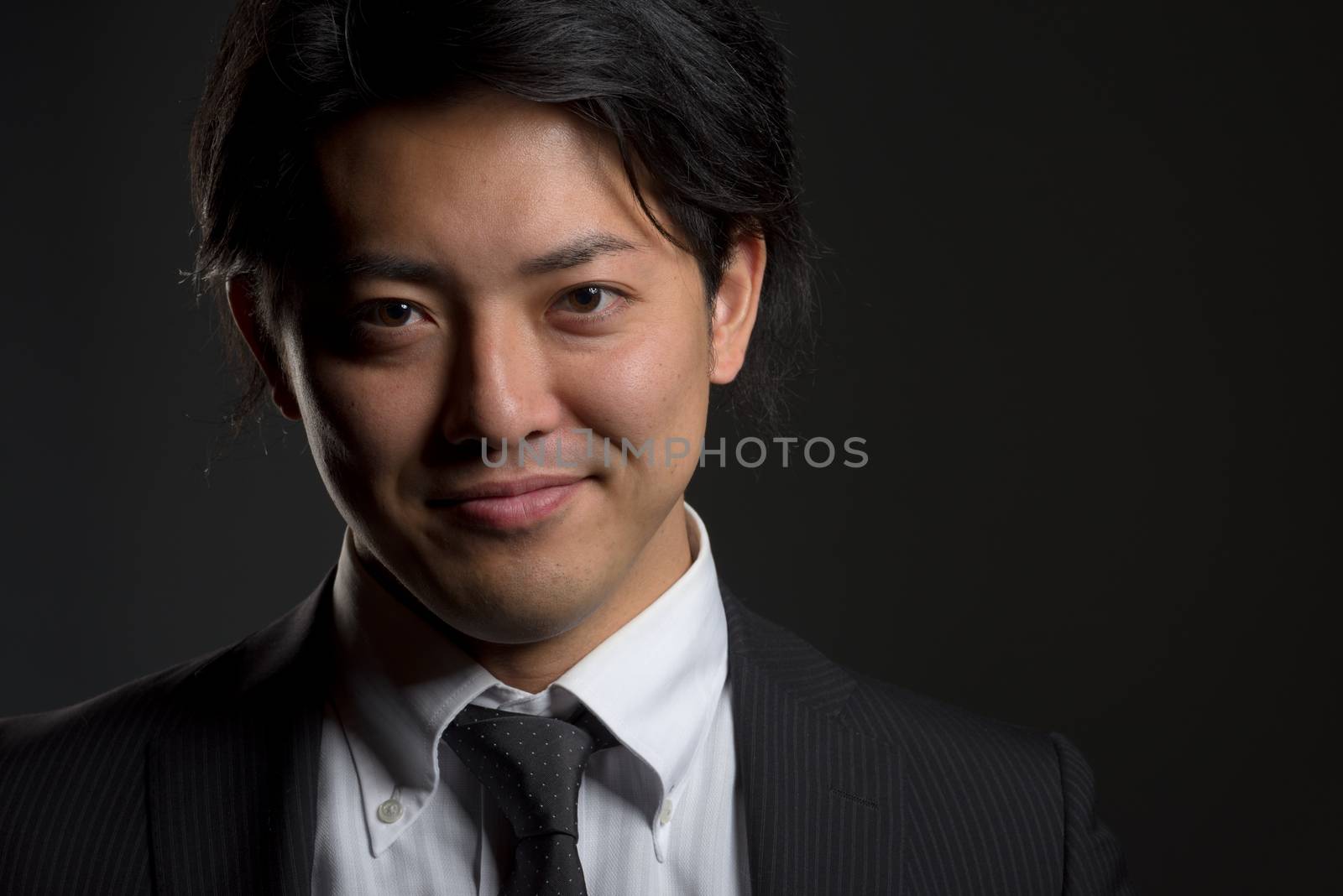 Dark and Smiling Asian Male Portrait by justtscott