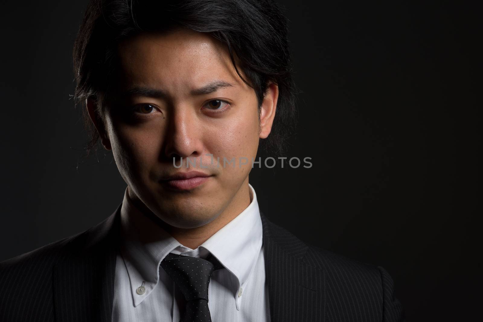 Dark and Smiling Asian Male Portrait by justtscott