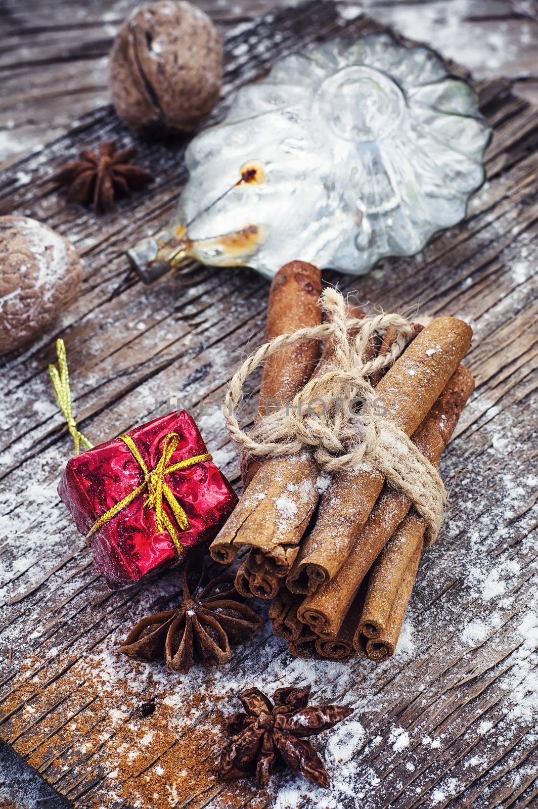 Old-fashioned Christmas decorations,cinnamon sticks,star anise and nuts on wooden retro background
