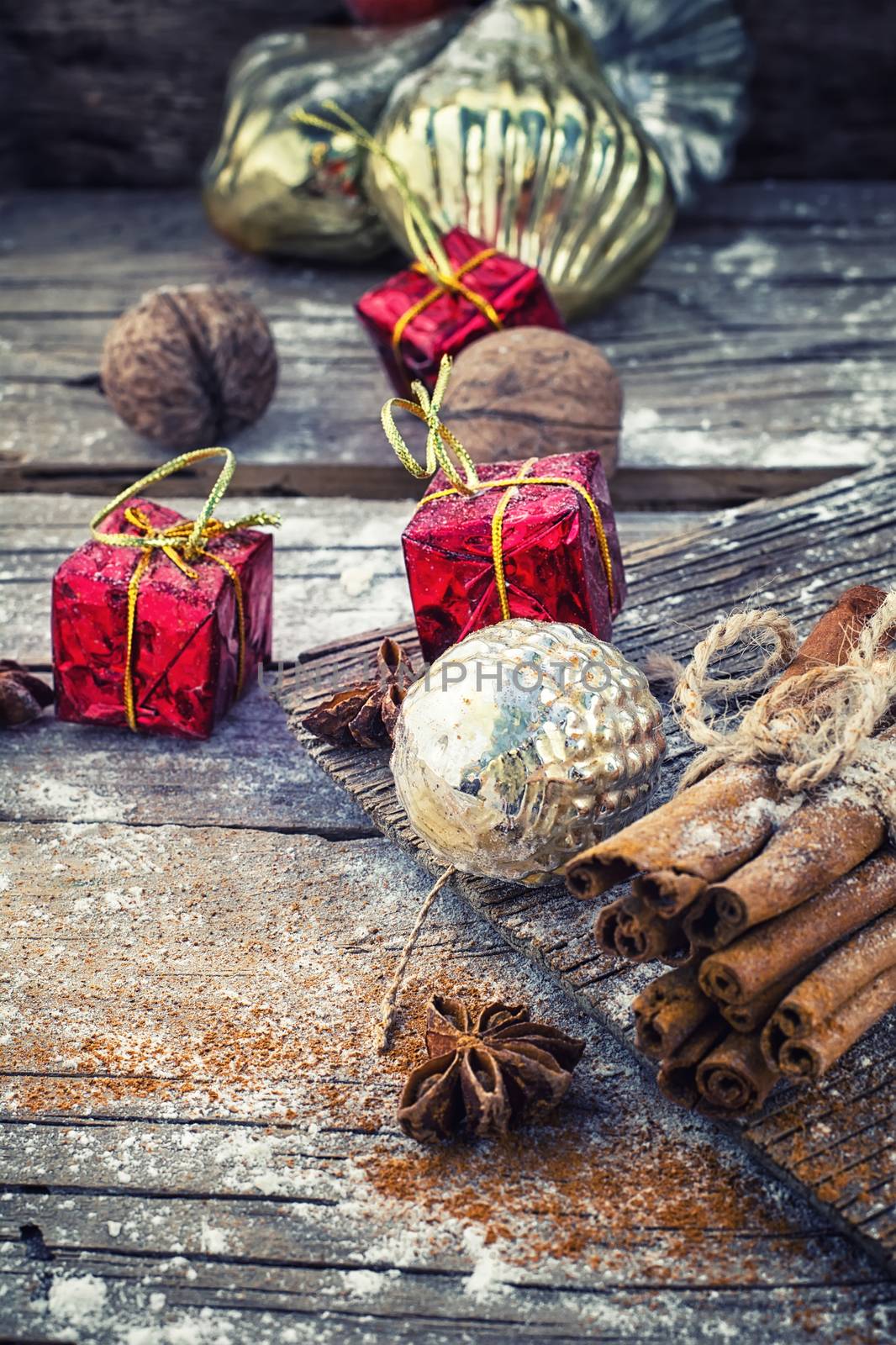 Old-fashioned Christmas decorations,cinnamon sticks,star anise and nuts on wooden retro background