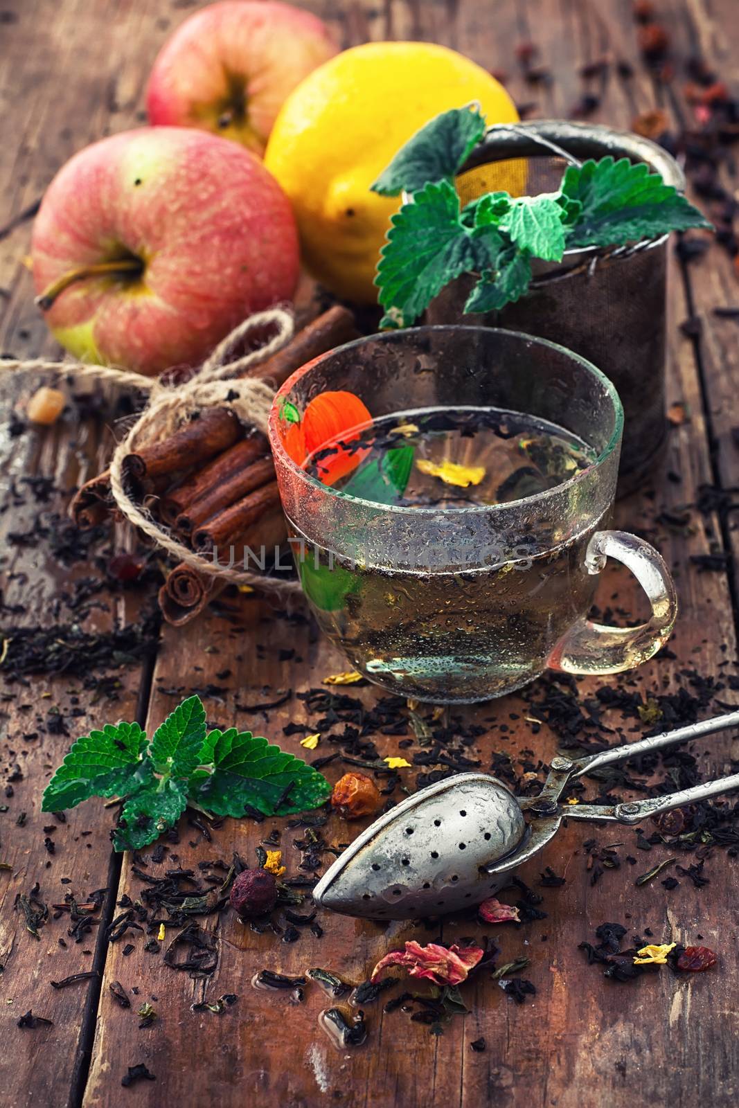 Cup with herbal tea on background apples and cinnamon