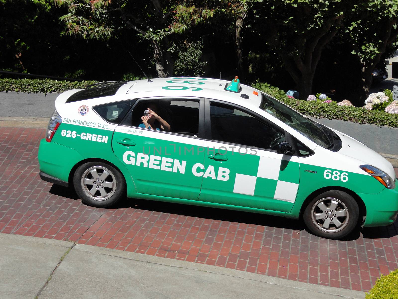 San Francisco, USA - July 22 2010: Toyota Prius Hybrid Taxi on the famous Lombard Street. Green Cab (SF Green Cab) is an Ecological Taxi company located in San Francisco, California