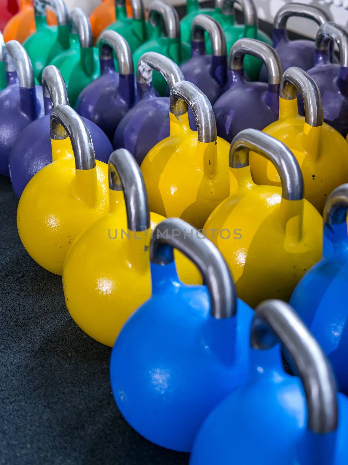 Photo of many kettlebells at a crossfit gym. 
