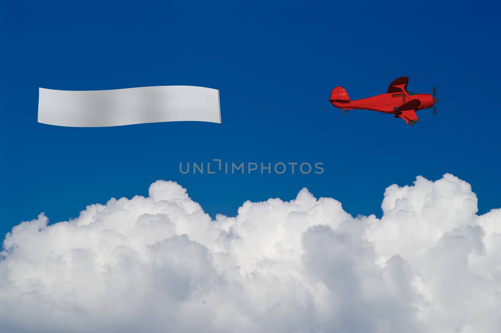 Red plane pulls blank banner above white clouds by vkstudio