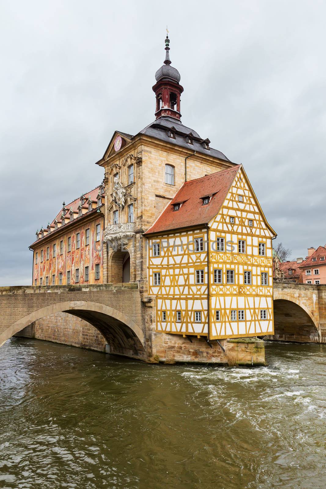 The old Town Hall in Bamberg built in the middle of the river Regnitz, in Upper Franconia, Bavaria, Germany, with facade covered with colourful frescoes.