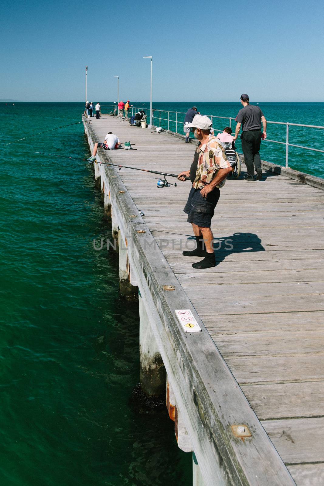 MELBOURNE/AUSTRALIA - FEBRUARY 6: Locals fishing on the jetty in Mordialloc which is a coastal suburb of Melbourne, Ausralia.