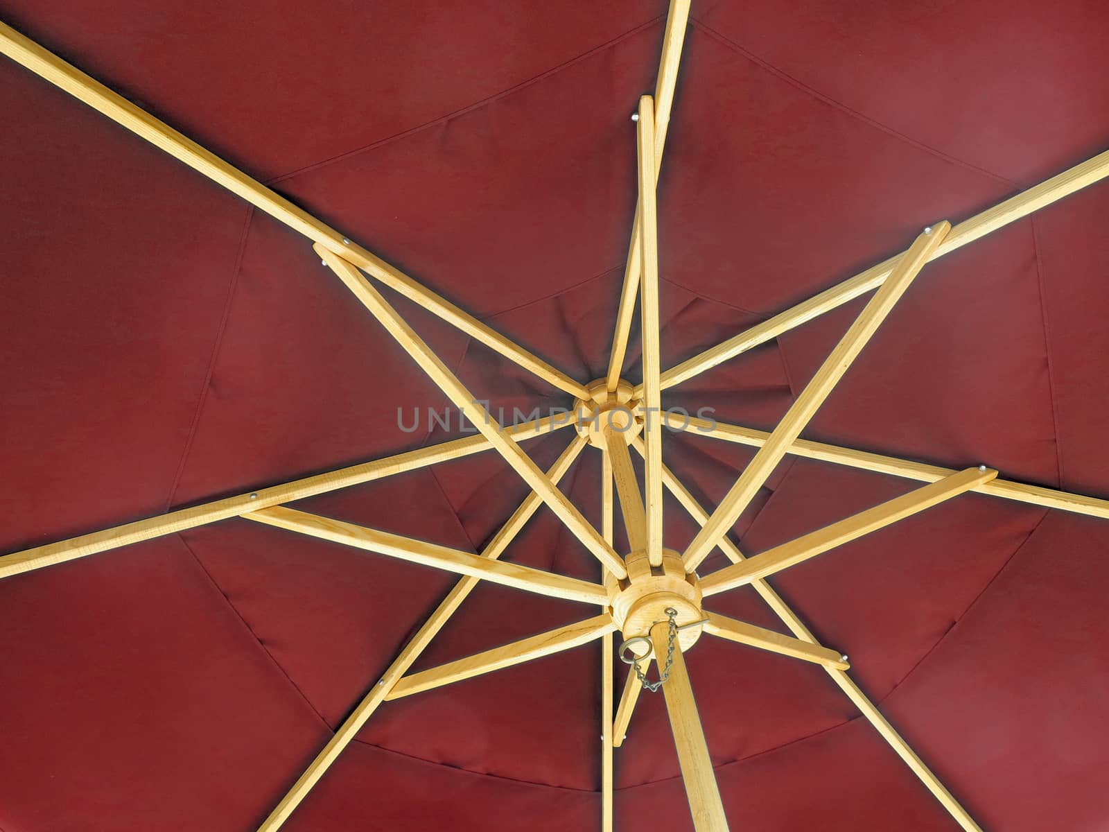 The inside of an open red umbrella