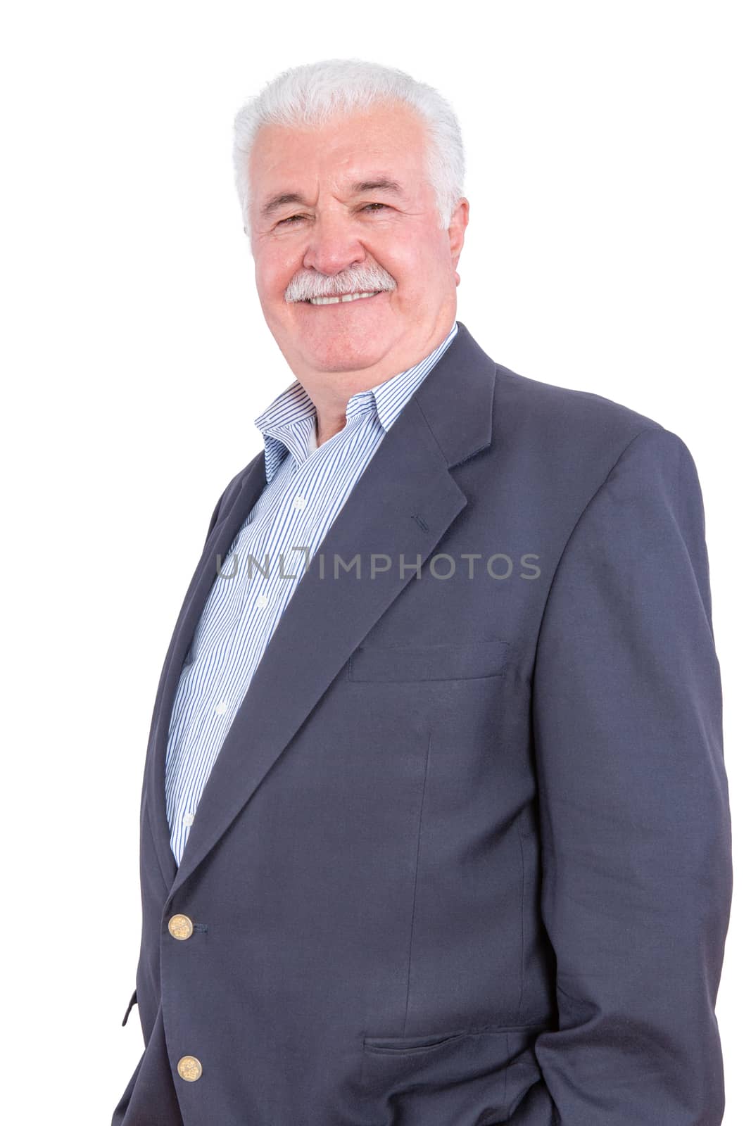 Dignified mature man in white hair and mustache standing over white background with hands in pockets of blue blazer