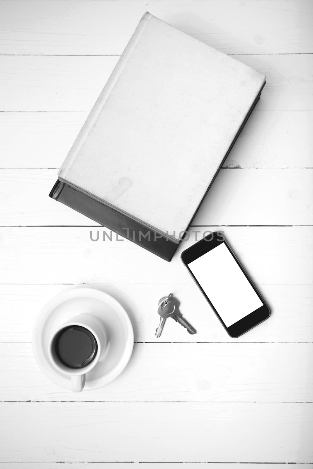 coffee cup with phone,key and stack of book black and white colo by ammza12